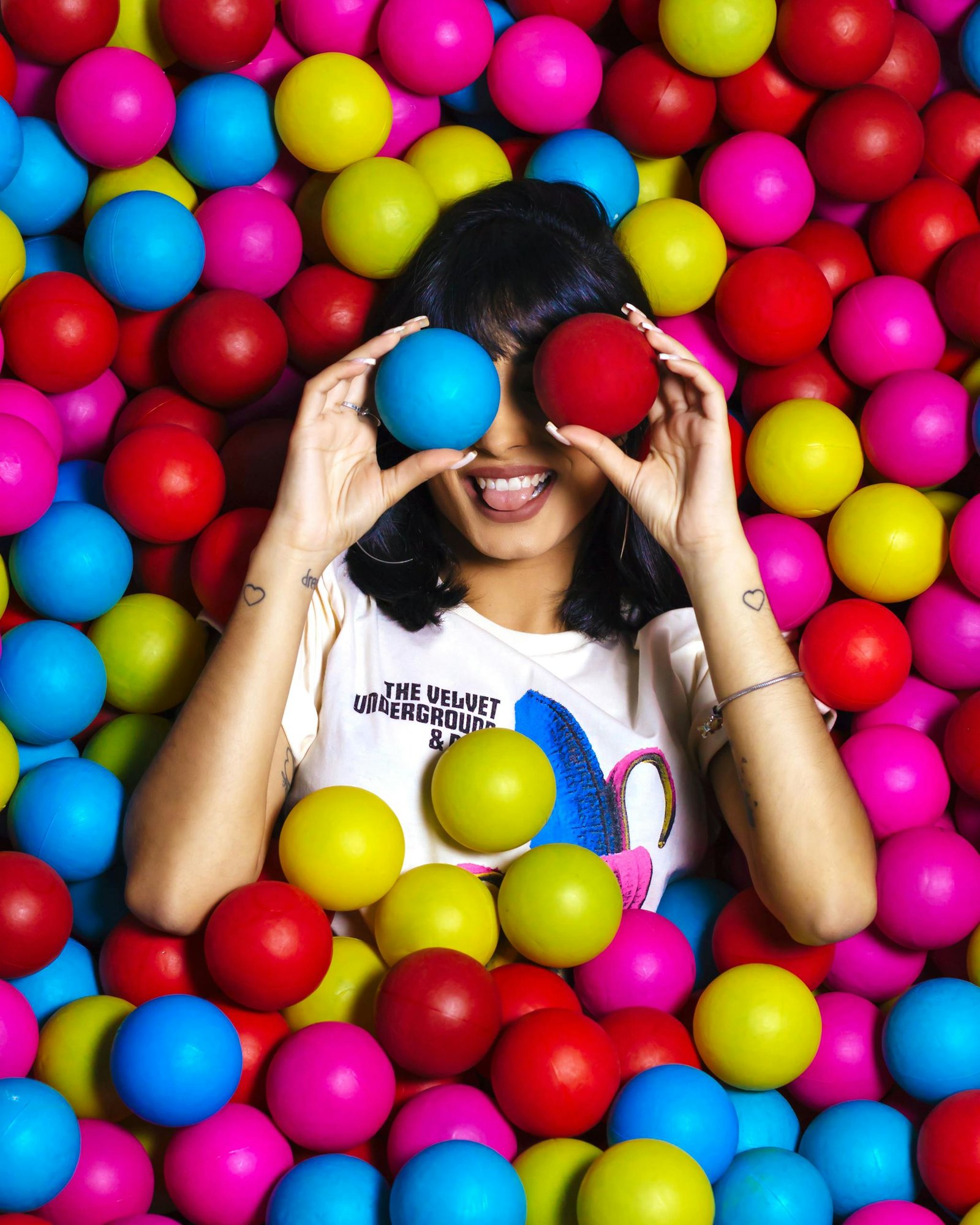 Photo Of Woman Laying On Assorted-Colored Balls