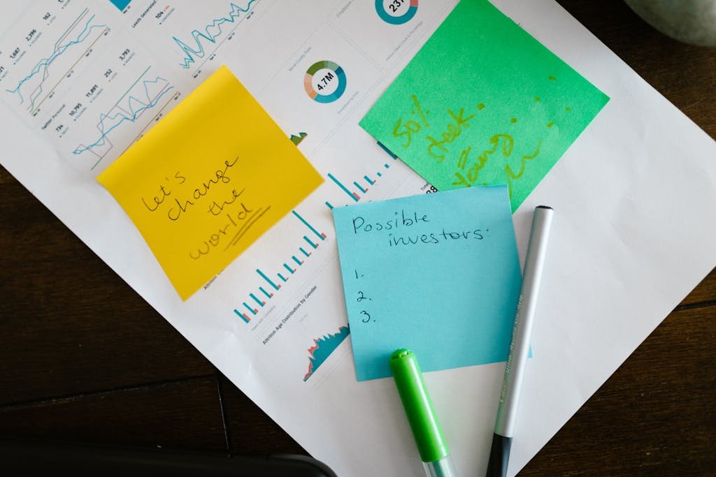 Startup brainstorming with charts, colorful sticky notes, and planning strategies for success.